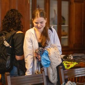 A student searches for cool clothes at a Trash to Treasure Clothing Swap.
