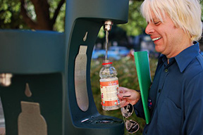 History lecturer Van Herd fills up his water bottle at a water bottle filler station 