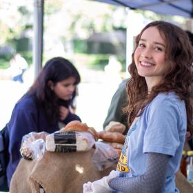 A UT Farm Stand volunteer smiles during a spring semester event.