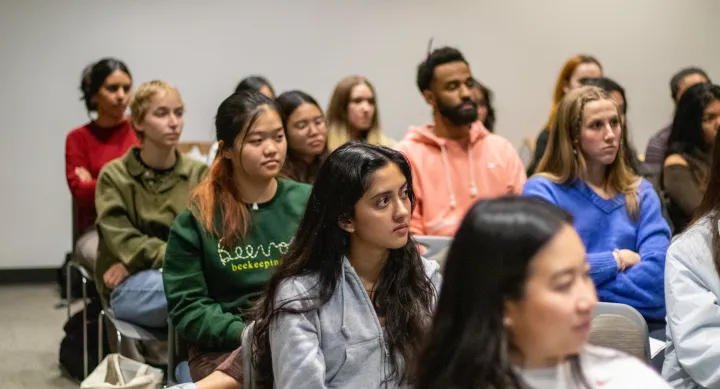 Students listen to a presentation.
